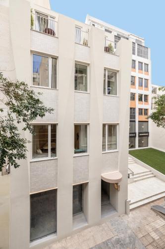an apartment building with a white facade at Milioni by Oniro in Athens