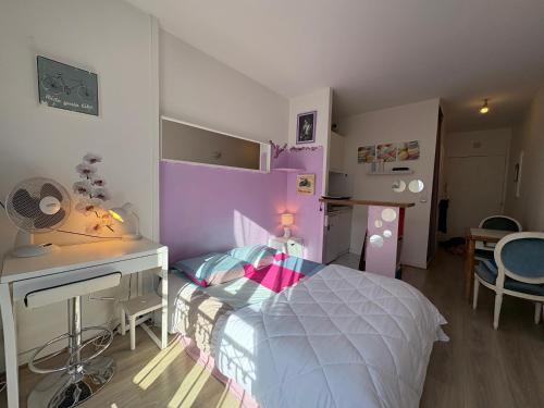 a bedroom with a bed and a desk and a table at Paris Saint Maurice Montgolfier in Saint-Maurice