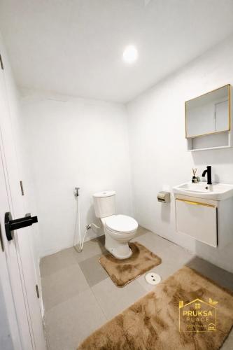 a bathroom with a toilet and a sink at Pruksa Place Udon Thani in Udon Thani