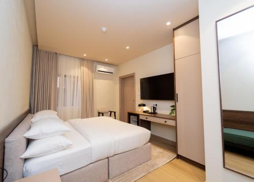 a hotel room with a bed and a desk at 7EVEN Suites in Lagos