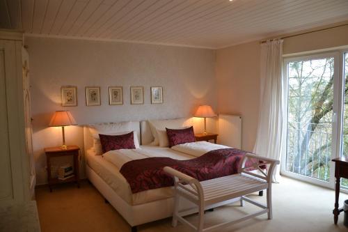 a bedroom with a large bed and a window at Christian Gartenhotel in Nieder-Olm