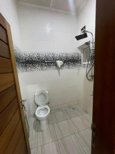 a bathroom with a toilet and a shower at Mtwapa- North Coast in Mtwapa