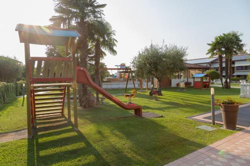 a playground with a slide in a park at Residence La Margherita in Lazise