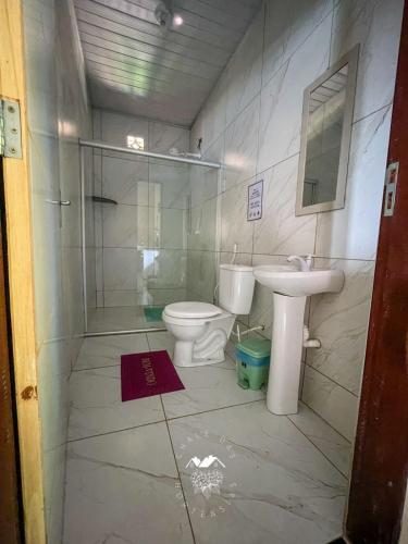 a bathroom with a toilet and a sink at Casarão Vale das Hortênsias in Bonito