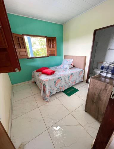 a small bedroom with a bed and a window at Casarão Vale das Hortênsias in Bonito