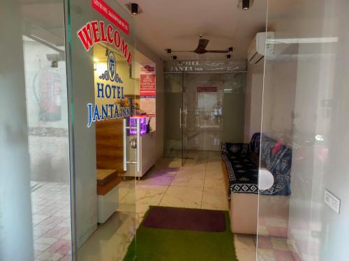 a welcome to a hotel restaurant with a neon sign at HOTEL JANTA INn in Vapi