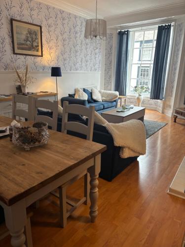 a living room with a couch and a table at Compton House 1, Sea & Castle Views in Conwy
