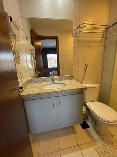 a bathroom with a sink and a toilet at Flat Veredas 305 com ar condicionado sala - 300 metros do Hot Park in Rio Quente