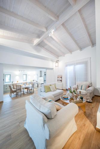a living room with two couches and a table at Villa Oliva with Private Pool by Konnect in Kato Korakiana