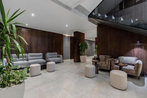 a lobby with couches and chairs and plants at Villa Elena SPA & Resort in Bukovel