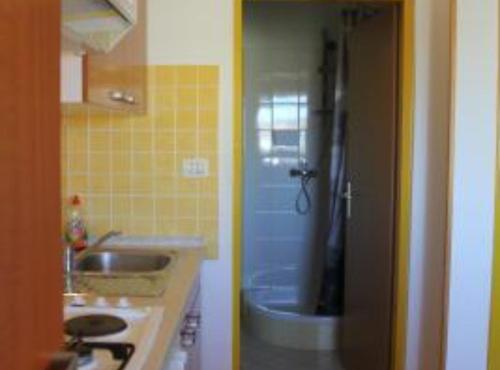 a bathroom with a shower and a sink and a tub at Sanja Apartments Posedarje in Posedarje