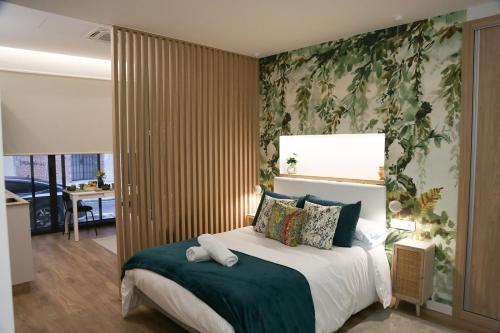 a bedroom with a large bed with a green wall at Apartamento Diseño Myrtus in Ponteareas