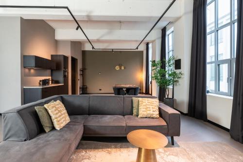 a living room with a couch and a table at Hilversum City Apartments in Hilversum