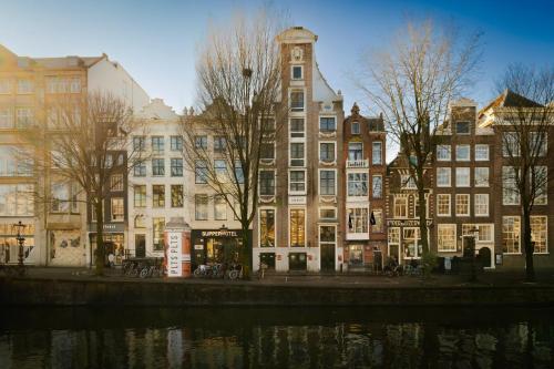 a group of buildings in front of a river at Supper Boutique Suites in Amsterdam