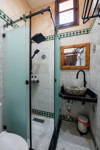 a bathroom with a shower and a sink at Riad Jasmine in Rabat