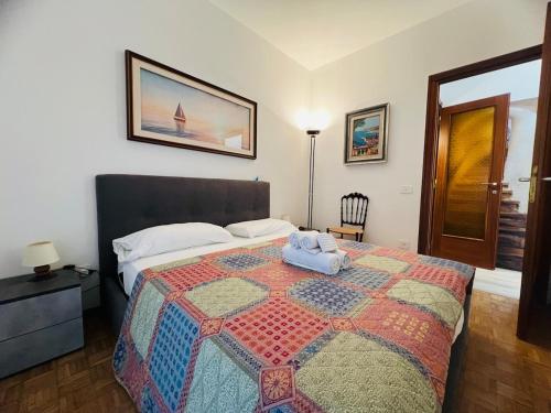 a bedroom with a bed with a quilt on it at Suite Semeria 466 - Sanremo in Sanremo