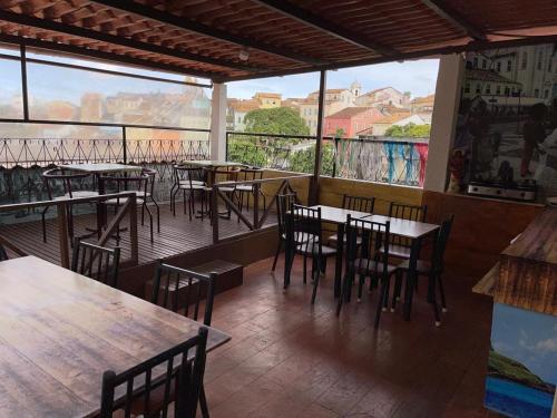 a restaurant with tables and chairs on a balcony at Pousada Bahia Morena in Salvador