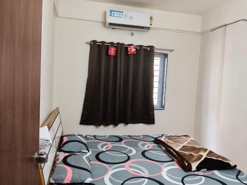 a bedroom with a bed with a black curtain at Punawale tathwade 1bhk in Méribel Village