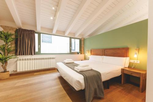 a bedroom with a bed and a large window at Bravissimo Força 17, Barri Vell apartments in Girona