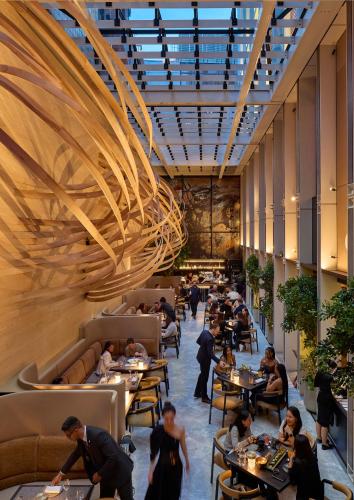a restaurant with people sitting at tables in a building at Mandarin Oriental Mayfair, London in London