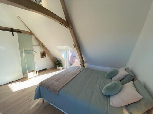 a bedroom with a bed with pillows and a window at The BEE Garden in Lede