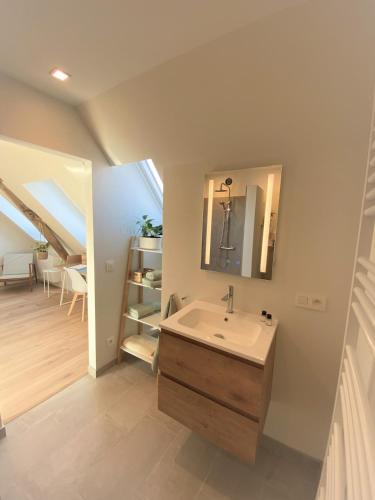 a bathroom with a sink and a staircase at The BEE Garden in Lede