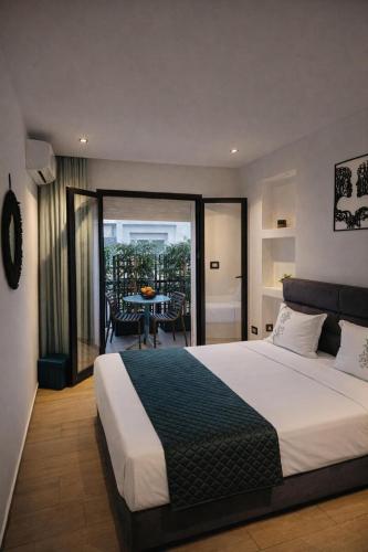 a bedroom with a bed and a balcony with a table at Captivating 2-Bed Apartment in Tunis in Tunis