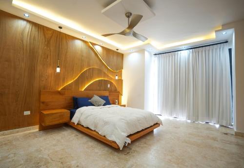 a bedroom with a large bed and a ceiling fan at Modern Villa with a 15m Lap Pool, Cabarete in Cabarete