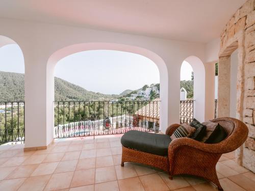 a living room with a couch and a balcony at Villa in Cala Llonga near Beach & Ferry Port in Cala Llonga