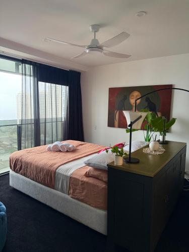 a bedroom with a bed and a painting on the wall at Sea-view apartment in the heart of Gold Coast in Gold Coast