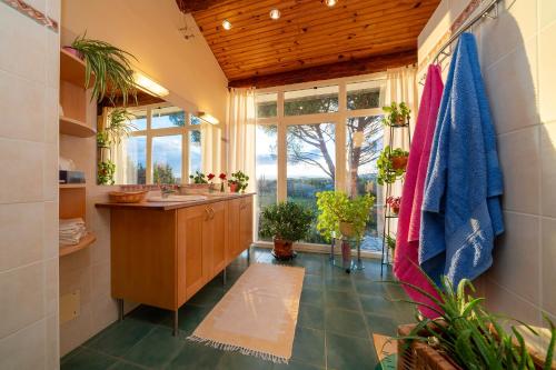 a bathroom with a sink and a large window at Le Petit Paradis in Labastide-de-Virac
