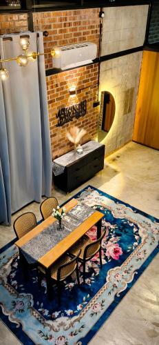 a dining room with a table and a fireplace at Sekinchan Tiny House - Moslim Only in Sekinchan