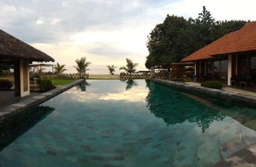 a swimming pool in front of a resort at Jepara Marina Beach Bungalows in Jepara