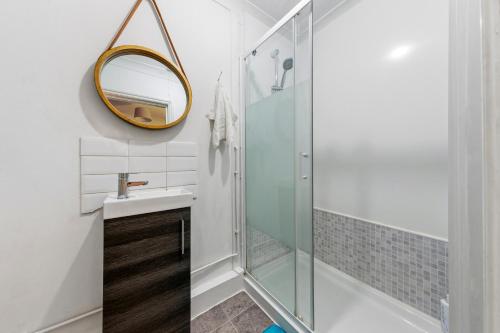 a bathroom with a shower and a sink and a mirror at Trendy 2Bed flat Bethnal Green in London