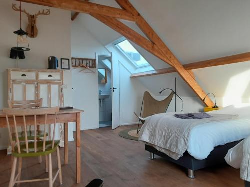 a bedroom with a bed and a desk and a table at Sport B&B De Veluwezoom in Velp