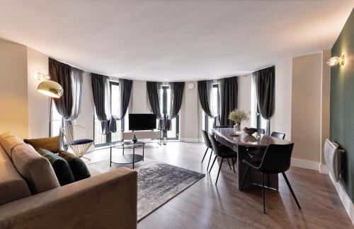 a living room with a couch and a table at Oxford Street Fitzrovia Apartments by DMONTRIO in London