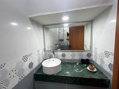 a bathroom with a sink and a mirror at Minh Minh Nam 3 Hotel in Can Tho