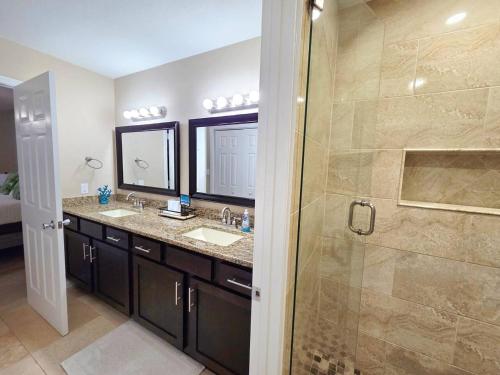a bathroom with two sinks and a shower at Nautical Costa Del Mar on Holiday Isle in Destin