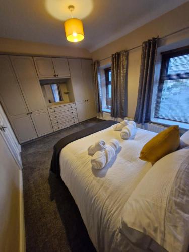 a bedroom with a bed with towels on it at Kellys Place Derry City Centre in Derry Londonderry