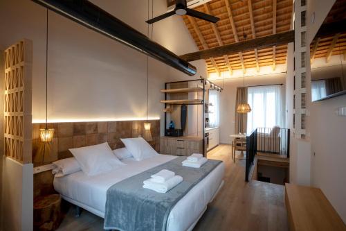 a bedroom with a bed with two towels on it at Mon Suites San Pedro in Valencia