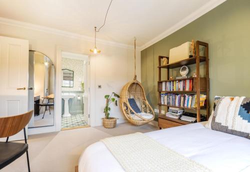 a bedroom with a bed and a book shelf at Kyuquot House in Woodbridge