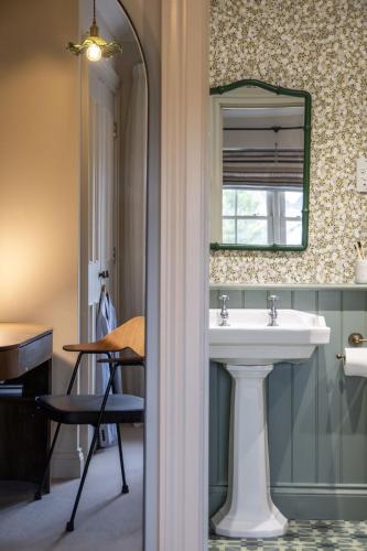 a bathroom with a sink and a mirror at Kyuquot House in Woodbridge