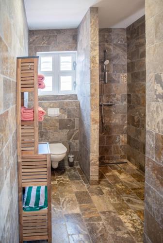 a bathroom with a toilet and a shower at Watervillas Breezy Bay in Kralendijk