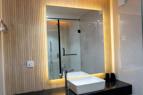 a bathroom with a white sink and a mirror at 7EVEN Suites in Lagos