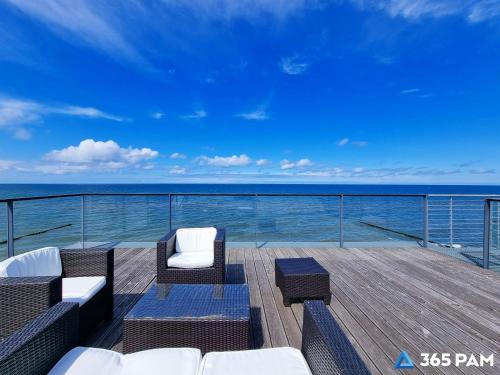 a balcony with chairs and a view of the ocean at 365PAM - Boulevard Z Widokiem Na Morze in Ustronie Morskie