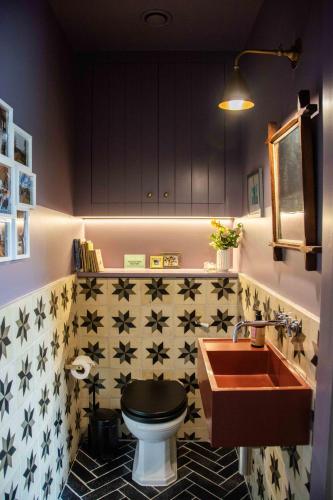 a bathroom with a toilet and a sink at The Barn at Manor Farm in Great Glemham