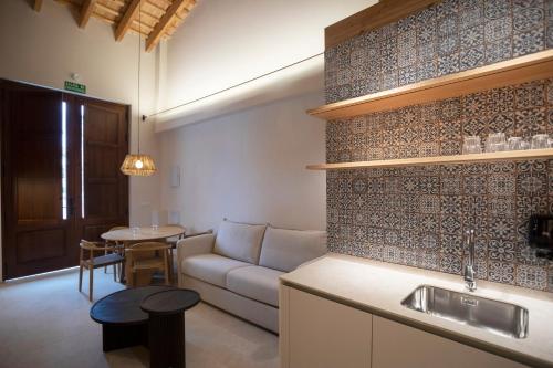 a living room with a couch and a table at Mon Suites San Pedro in Valencia