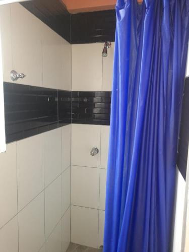 a shower with a blue curtain in a bathroom at Villa village 02 in Saint Lucia Island