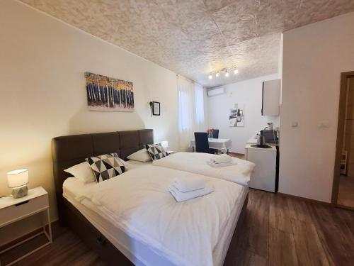 a bedroom with a large bed with white sheets at Apartments ATM in Šibenik
