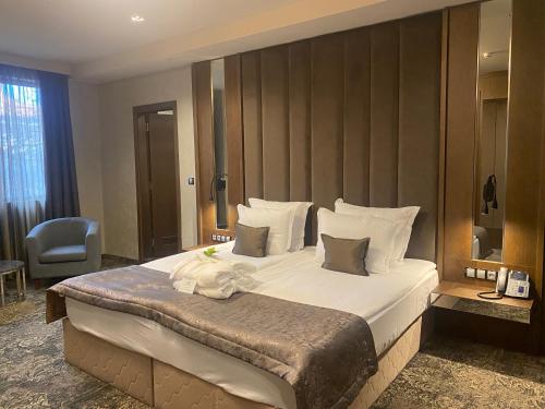 a bedroom with a large bed in a room at Hotel Royal Plovdiv in Plovdiv